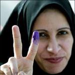 Iraqi woman gives peace sign after voting